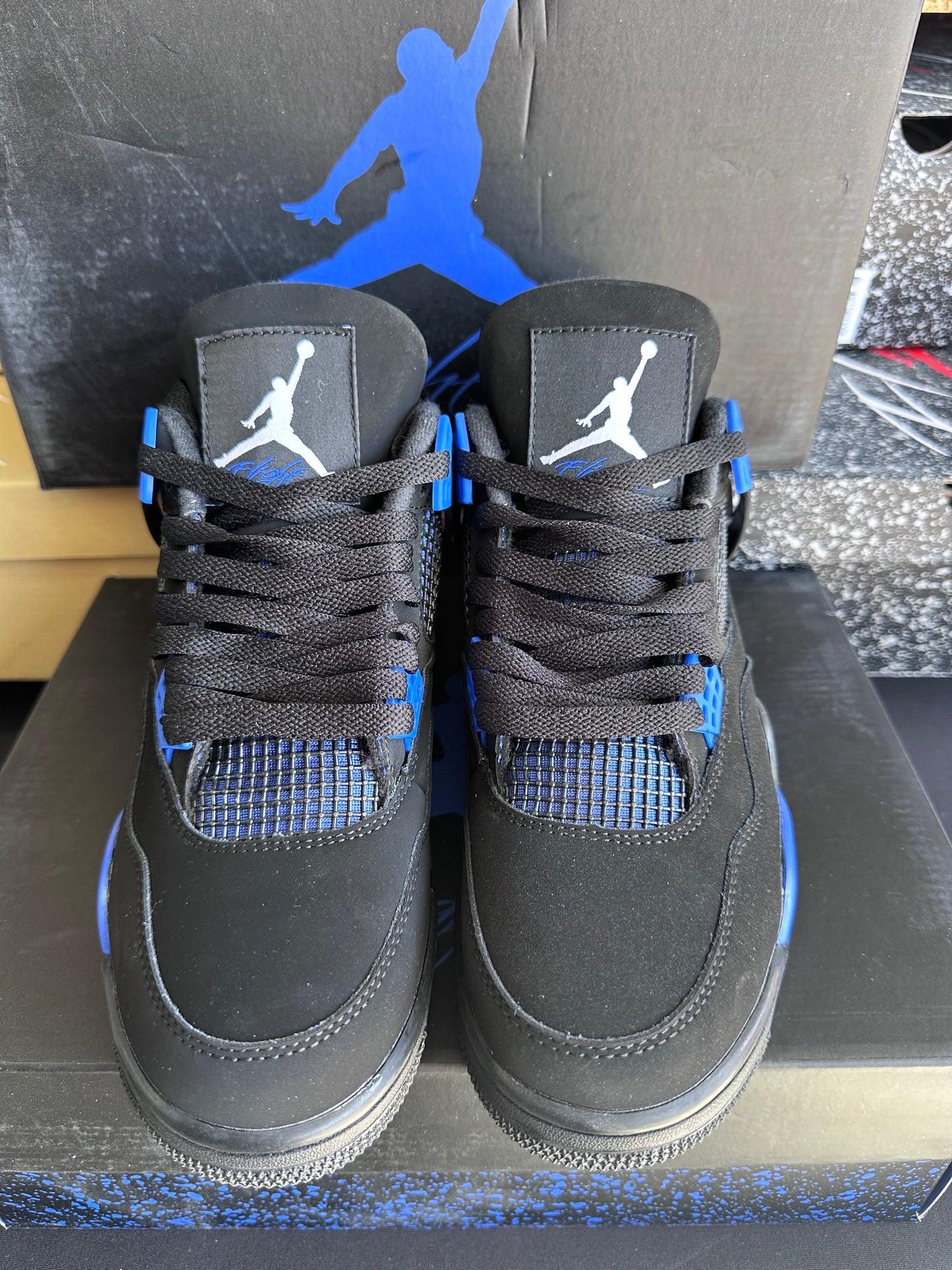 Black low top sneakers with royal blue accents