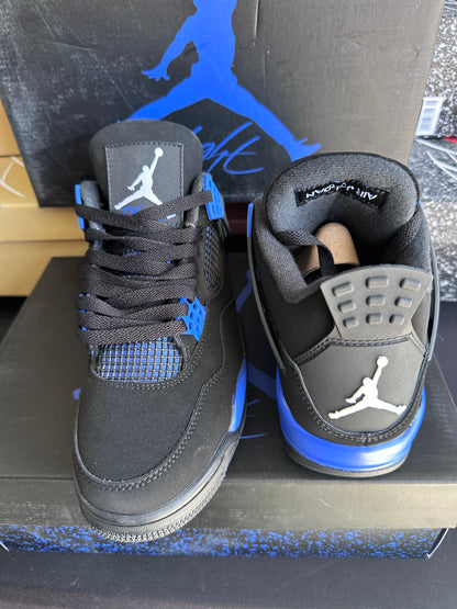 Side view of black sneakers with blue sole