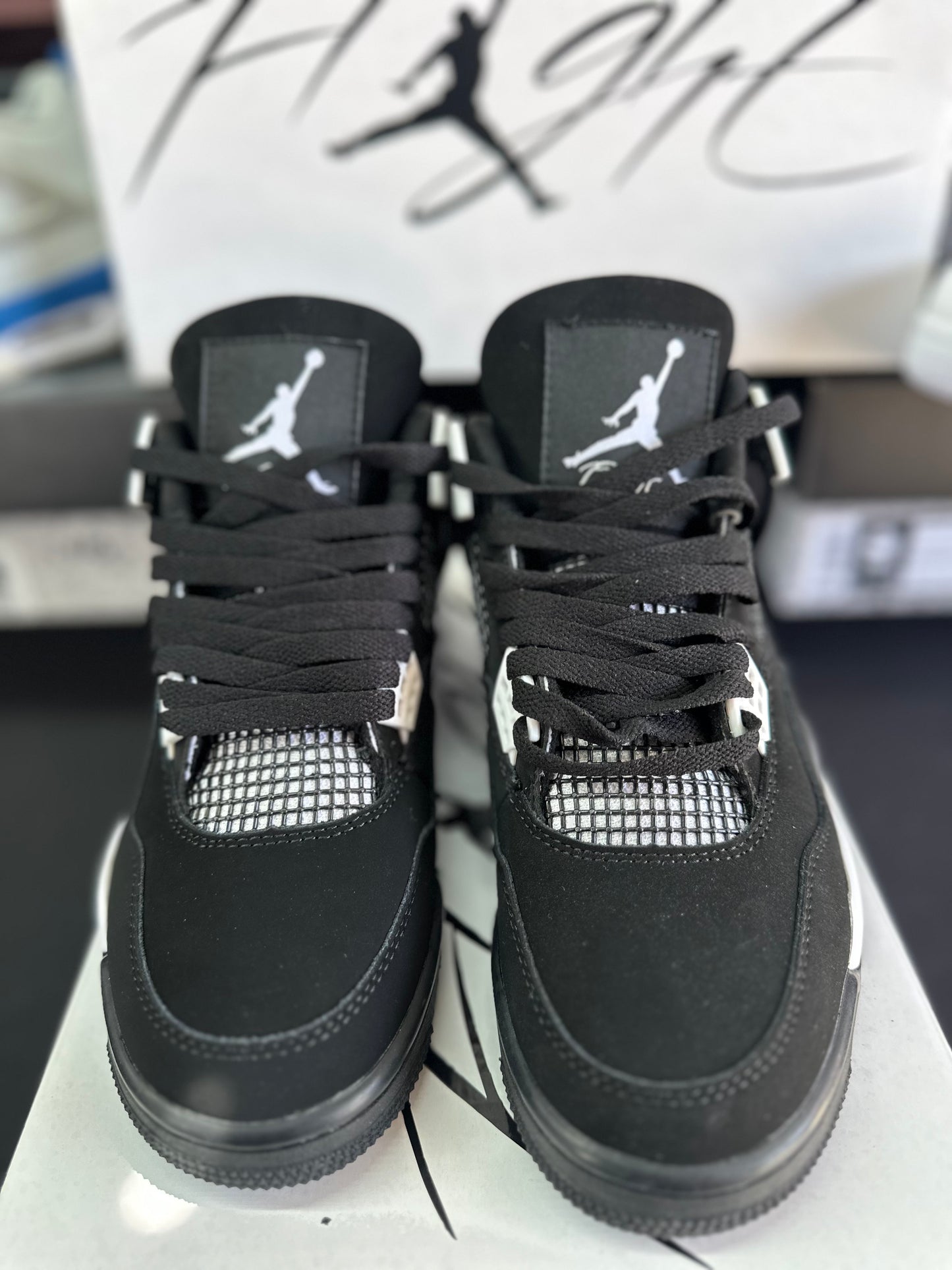 Black low top sneakers with white accents