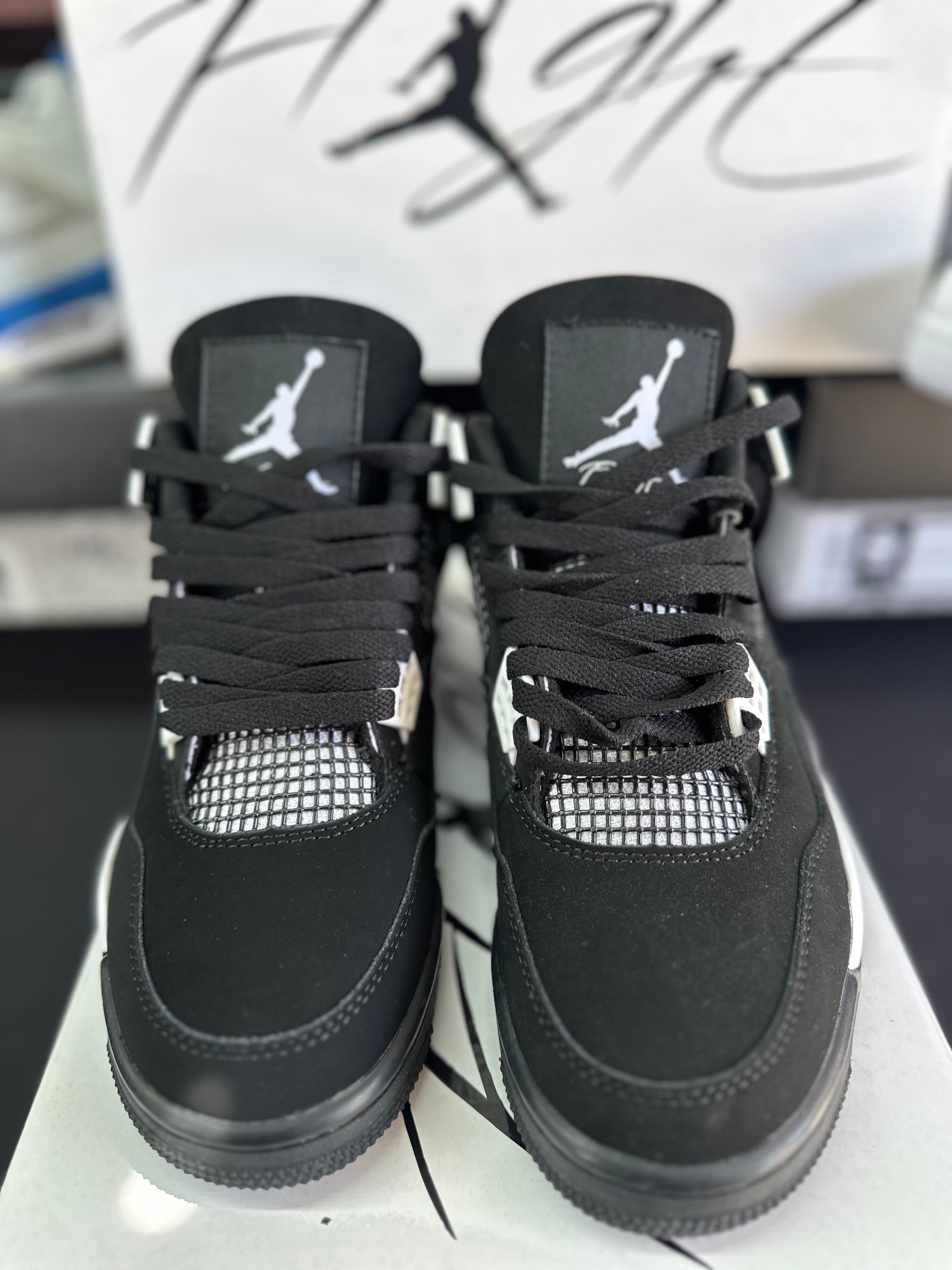 Black low top sneakers with white accents