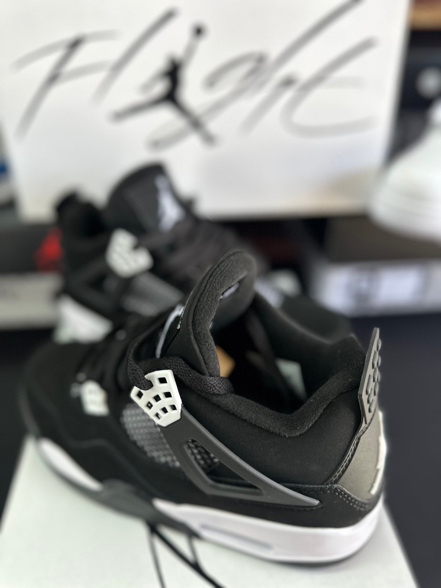 Side view of black sneakers with white midsole