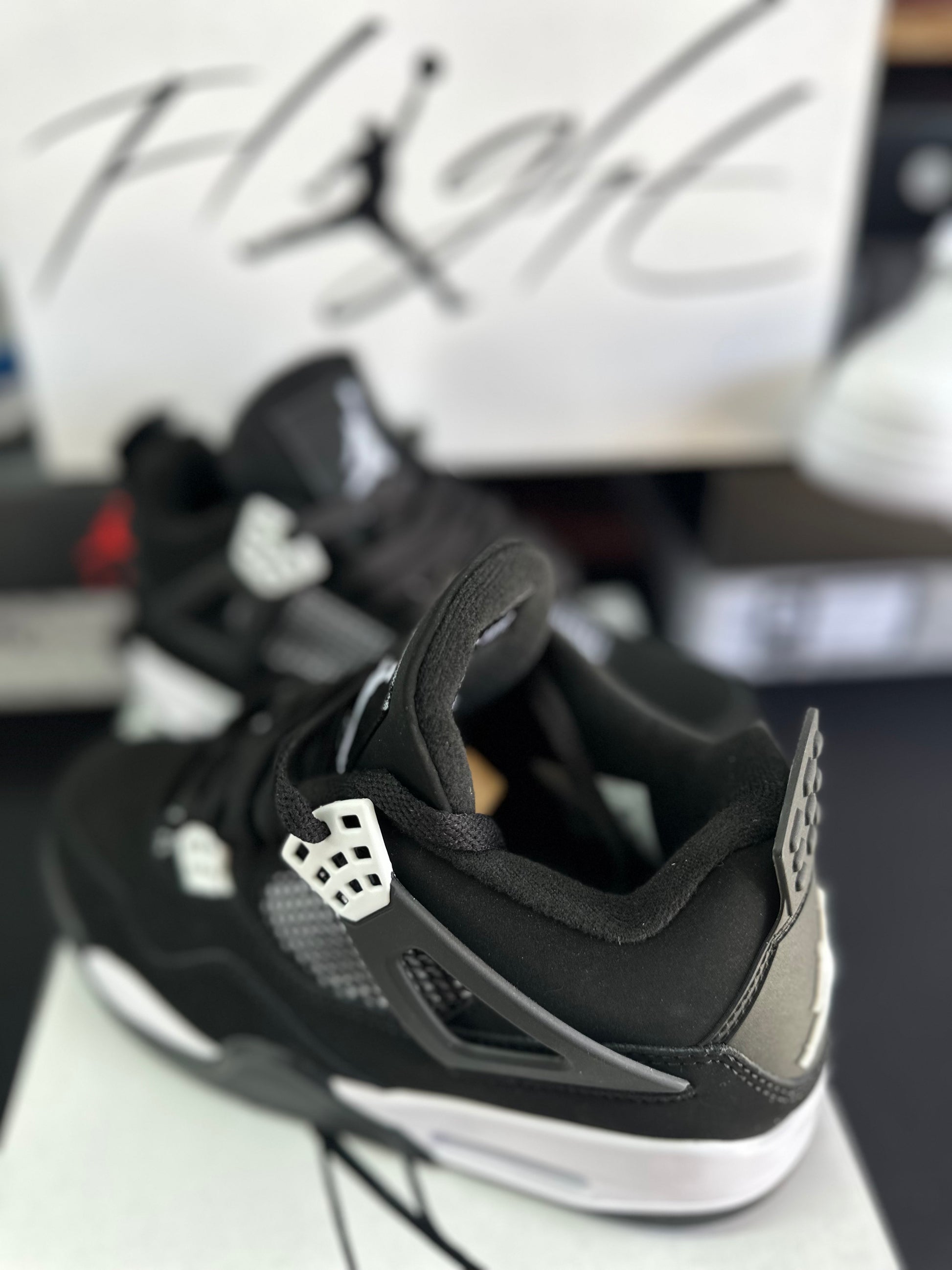 Side view of black sneakers with white midsole